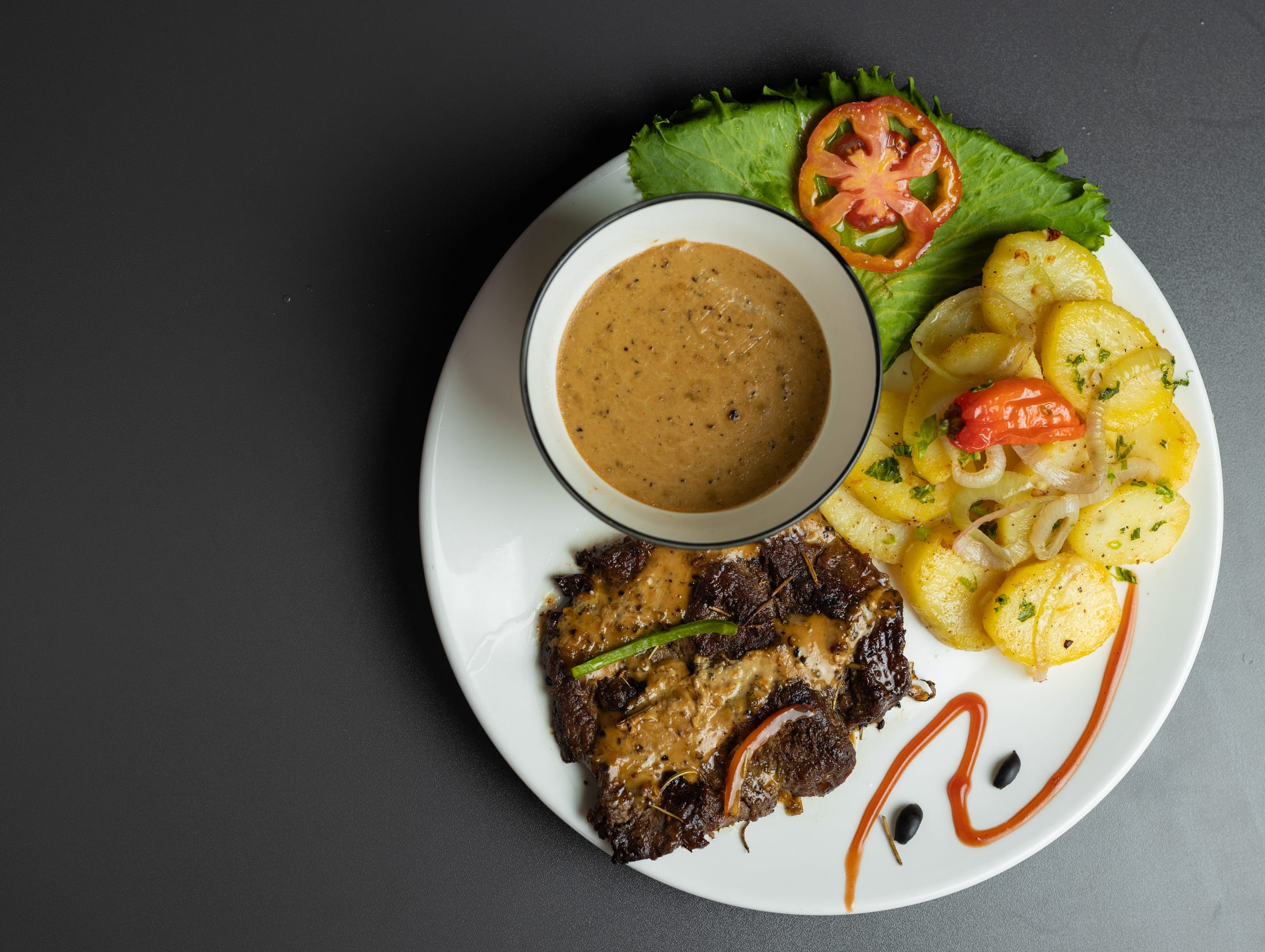 HILITE plated steak with potatoes and pepper sauce